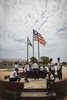 Students stand under the Liberian flag during a break at the R.S. Caufield Public School in Unification, Liberia