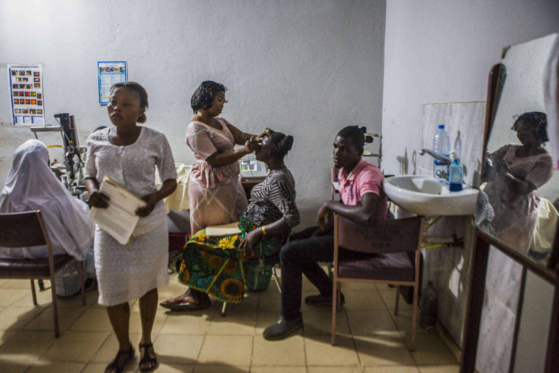 Ophthalmic nurse Hannah Dorwie, 32, (center) measures the curvature of the eye of an Ebola survivor at the Kissy United Methodist Church Eye Hospital in Freetown, Sierra Leone. Long after recovering from the largest Ebola outbreaks in history, survivors continue to experience debilitating complications including uvetis, an inflammation of the eye, leading to severe cataracts leaving the survivor with little to no sight in the affected eye. Doctors from Emory University Hospital have traveled to Sierra Leone to restore the sight of survivors suffering from severe cataracts in an effort to help them return to a more normal life. 