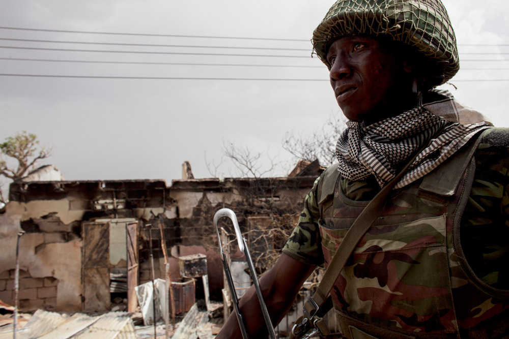 A member of the Nigerian military rides through Gwoza after the Nigerian military regain control from Boko Haram in April 2014.