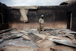 A member of Nigeria's military walks through a destroyed school in Gwoza, Nigeria in April 2014. 