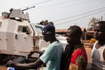 A United Nations APC passes people riding a motorbike on the streets of Bangui, Central African Republic