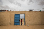 A boy stands in a doorway at an internment camp for ex-Boko Haram combatants in Goudoumaria, Niger, August 2018. 