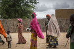Women walk through Boudouri Internally Displaced persons camp outside of Diffa, Niger, September 2018.The original village of Boudouri housed between 200-300 people but now, because of the crisis, over 5000 take refuge with little to no aid for the last five months. 