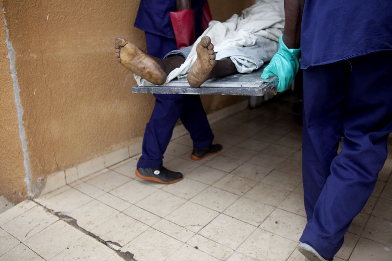 The body of a man killed due to post election crisis is brought into a morgue in Abidjan, Ivory Coast