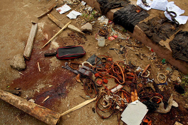 Amulets worn for protection, clothing and other belongings are displayed across a blood stained street after heavy fighting between pro-ouatrrara supporters and security forces loyal to Laurent Gbagbo in opposition neighbodhood, Abobo in Abidjan, Ivoru Coast