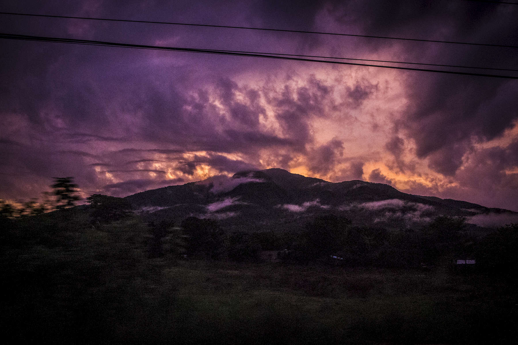 The sun rises over a volcano in El Salvador June 2018. (Jane Hahn)