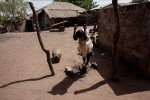 Ibrahima, 12, plays on a clothes line in Dampha Kunda Village