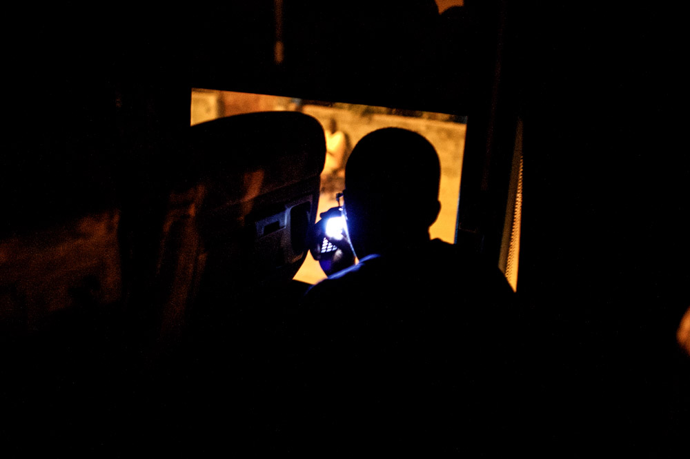 Amadou looks out the window from the bus as he begins the {quote}back way {quote} journey traveling from Banjul, Gambia through three other countries before reaching Agadez, Niger where he will cross the desert to Libya before making his way to Europe