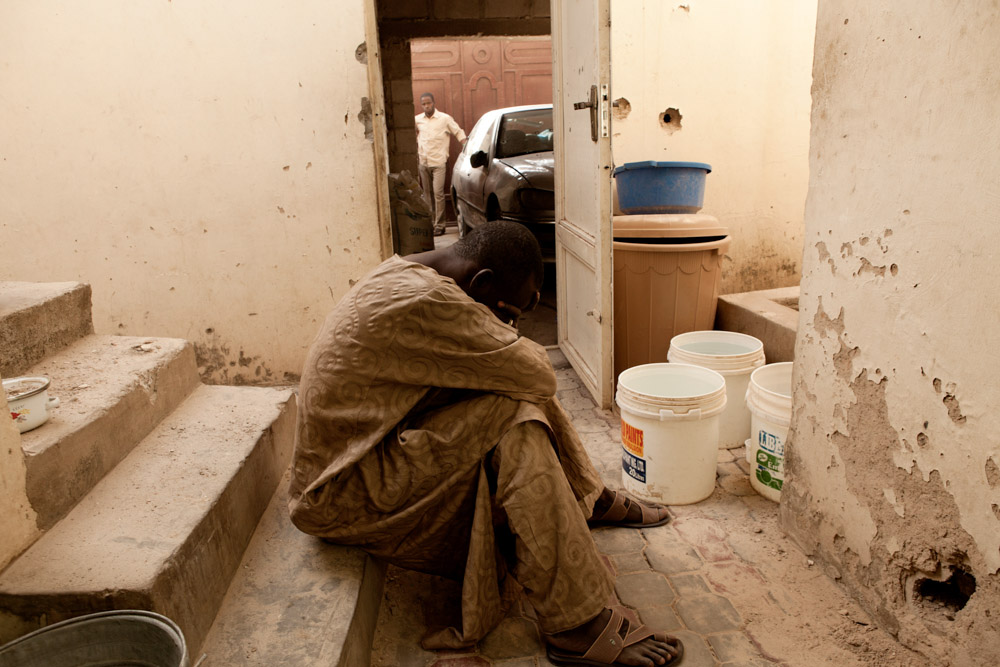 A relative of Uzairu Abba Abdullahi grieves the morning after he and his wife were killed in an overnight raid by Nigerian security forces, who accused him of being a member of Boko Haram, in the Tsamiyar Boka neighborhood in Kano, Nigeria. 2012