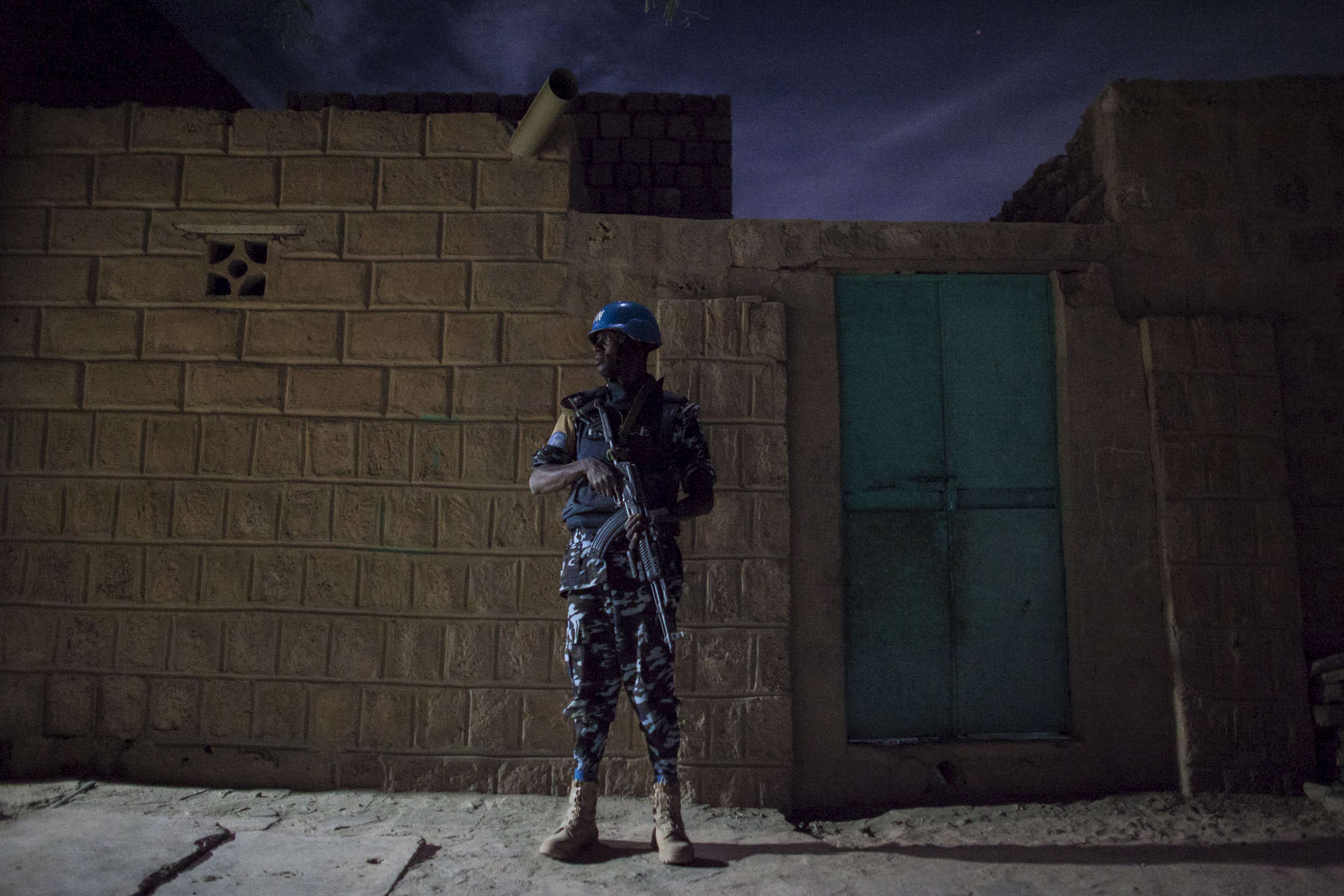 A United Nations police officer stands on guard during a night patrol in the Abaradiou neighborhood in Timbuktu, Mali. Despite the end of the occupation, many Malians in Timbuktu find that security is still a major issue speaking of incidents of car jacking and looting. Even though crime is high, most of the deadly attacks that occur are against the United Nations Minusma mission, Malian soldiers and the French military. 