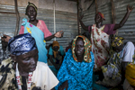 Women pray at a Pentecostal church in the Protection of Civilians (POC) site at the United Nations Mission in South Sudan (UNMISS) compound in Malakal, South Sudan on Saturday, July 9, 2016. The Malakal POC site houses over 32,000 displaced people mainly from the Shilluk and Nuer tribes. In February of this year, members of the Dinka tribe, who resided in the camp at the time, carried out a coordinated attack within the site leading to the destruction of hundreds of shelters and many deaths. Since then, most members of the Dinka tribe have fled to Malakal town where they occupy the homes of those still displaced. 