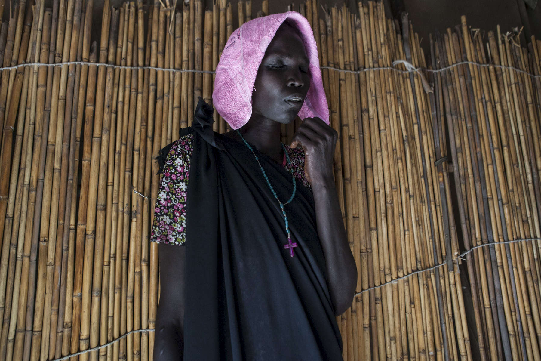 A woman prays at a Pentecostal church in the Protection of Civilians (POC) site at the United Nations Mission in South Sudan (UNMISS) compound in Malakal, South Sudan on Saturday, July 9, 2016. The Malakal POC site houses over 32,000 displaced people mainly from the Shilluk and Nuer tribes. In February of this year, members of the Dinka tribe, who resided in the camp at the time, carried out a coordinated attack within the site leading to the destruction of hundreds of shelters and many deaths. Since then, most members of the Dinka tribe have fled to Malakal town where they occupy the homes of those still displaced. 