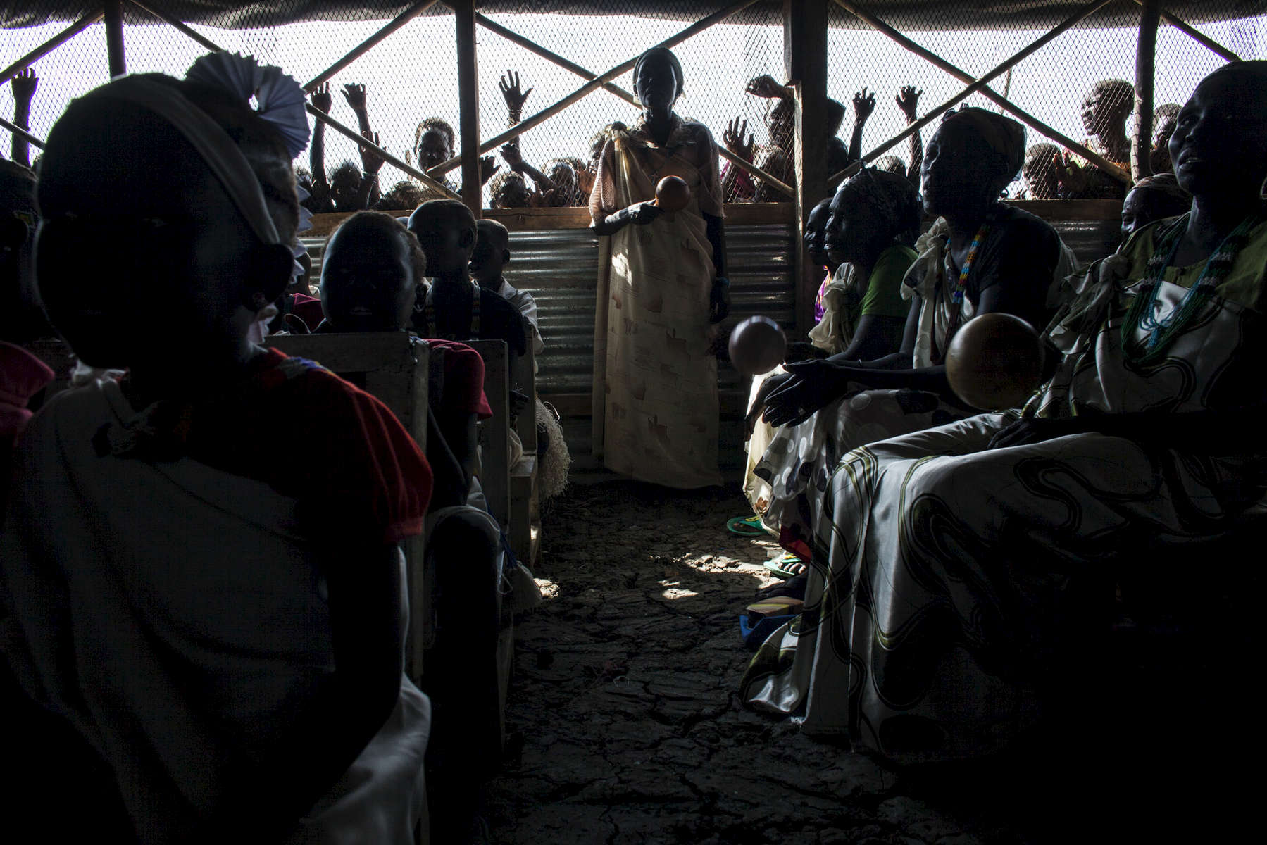 Church members pray at the Dolieb Hill Presbyterian Church in the Protection of Civilians (POC) site at the United Nations Mission in South Sudan (UNMISS) compound in Malakal, South Sudan on Saturday, July 9, 2016. The Malakal POC site houses over 32,000 displaced people mainly from the Shilluk and Nuer tribes. In February of this year, members of the Dinka tribe, who resided in the camp at the time, carried out a coordinated attack within the site leading to the destruction of hundreds of shelters and many deaths. Since then, most members of the Dinka tribe have fled to Malakal town where they occupy the homes of those still displaced. 