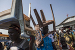 Church members carry out chairs and benches after service at the Dolieb Hill Presbyterian Church in the Protection of Civilians (POC) site at the United Nations Mission in South Sudan (UNMISS) compound in Malakal, South Sudan on Sunday, July 10, 2016. The Malakal POC site houses over 32,000 displaced people mainly from the Shilluk and Nuer tribes. In February of this year, members of the Dinka tribe, who resided in the camp at the time, carried out a coordinated attack within the site leading to the destruction of hundreds of shelters and many deaths. Since then, most members of the Dinka tribe have fled to Malakal town where they occupy the homes of those still displaced. 
