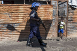 A member of the UN Police performs a search during a patrol in the Protection of Civilians (POC) site at the United Nations Mission in South Sudan (UNMISS) compound in Malakal, South Sudan on Tuesday, July 12, 2016. The Malakal POC site houses over 32,000 displaced people mainly from the Shilluk and Nuer tribes. In February of this year, members of the Dinka tribe, who resided in the camp at the time, carried out a coordinated attack within the site leading to the destruction of hundreds of shelters and many deaths. Since then, most members of the Dinka tribe have fled to Malakal town where they occupy the homes of those still displaced. 