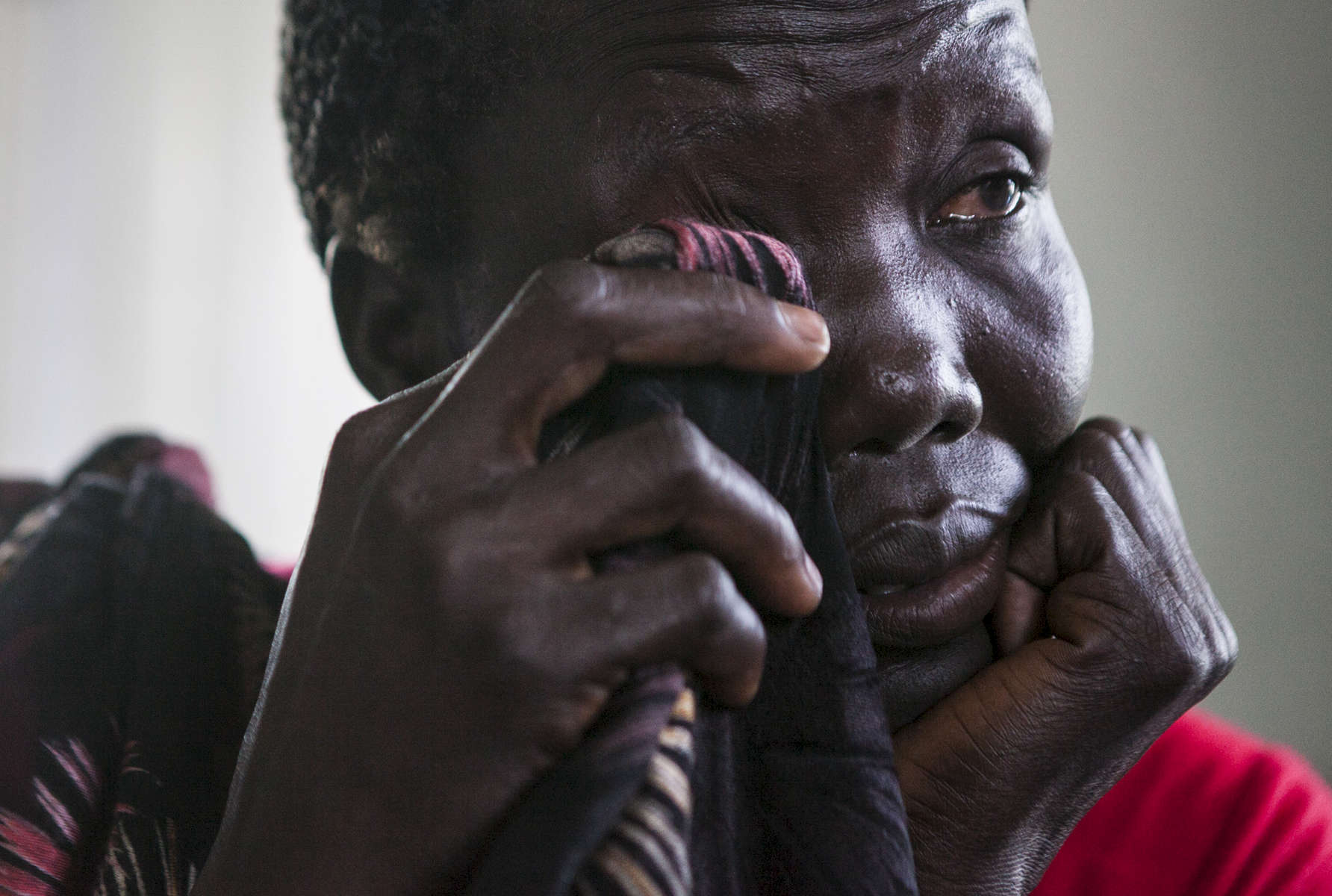 Mary Akich, 38, cries while recounting the circumstances around her son's death during the coordinated attack on February 17th and 18th of this year in the Protection of Civilians (POC) site at the United Nations Mission in South Sudan (UNMISS) compound in Malakal, South Sudan on Tuesday, July 12, 2016. The Malakal POC site houses over 32,000 displaced people mainly from the Shilluk and Nuer tribes. In February of this year, members of the Dinka tribe, who resided in the camp at the time, carried out a coordinated attack within the site leading to the destruction of hundreds of shelters and many deaths. Since then, most members of the Dinka tribe have fled to Malakal town where they occupy the homes of those still displaced. 