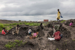 Children collect dirt to reinforce their shelters during the rainy season at the Protection of Civilians (POC) site at the United Nations Mission in South Sudan (UNMISS) compound in Malakal, South Sudan on Wednesday, July 13, 2016. The Malakal POC site houses over 32,000 displaced people mainly from the Shilluk and Nuer tribes. In February of this year, members of the Dinka tribe, who resided in the camp at the time, carried out a coordinated attack within the site leading to the destruction of hundreds of shelters and many deaths. Since then, most members of the Dinka tribe have fled to Malakal town where they occupy the homes of those still displaced. 