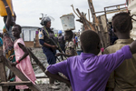 A member of the United Nations Police, UNPOL, stands guard during a routine search of contraband of the Protection of Civilians (POC) site at the United Nations Mission in South Sudan (UNMISS) compound in Malakal, South Sudan on Friday, July 15, 2016. The Malakal POC site houses over 32,000 displaced people mainly from the Shilluk and Nuer tribes. In February of this year, members of the Dinka tribe, who resided in the camp at the time, carried out a coordinated attack within the site leading to the destruction of hundreds of shelters and many deaths. Since then, most members of the Dinka tribe have fled to Malakal town where they occupy the homes of those still displaced. The UN has assured the displaced people that increased security measures around the camp will protect them from any further attack. Most of the displace are not convinced. 
