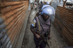 Members of the United Nations Police patrol the Protection of Civilians Site searching for contraband in Malakal, South Sudan on Friday, July 15, 2016  