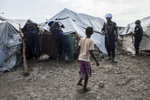 A young girl watches as members of the United Nations Police, UNPOL, searches shelters for contraband in the Protection of Civilians (POC) site at the United Nations Mission in South Sudan (UNMISS) compound in Malakal, South Sudan on Friday, July 15, 2016. The Malakal POC site houses over 32,000 displaced people mainly from the Shilluk and Nuer tribes. In February of this year, members of the Dinka tribe, who resided in the camp at the time, carried out a coordinated attack within the site leading to the destruction of hundreds of shelters and many deaths. Since then, most members of the Dinka tribe have fled to Malakal town where they occupy the homes of those still displaced. The UN has assured the displaced people that increased security measures around the camp will protect them from any further attack. Most of the displace are not convinced. 