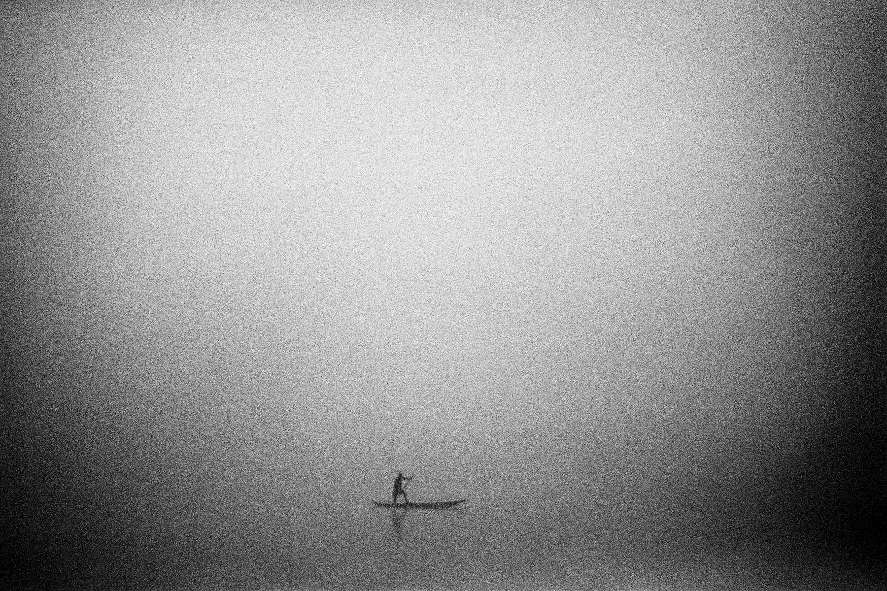A pirogue crossing the Tshuapa River in early morning fog  ** signature image of collection **