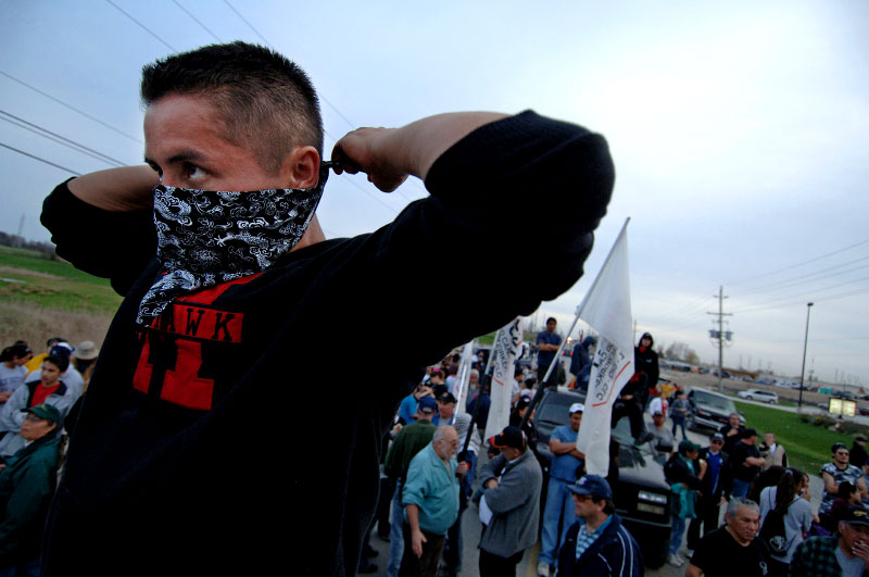 A Six Nations warrior stands on a barricade after police attempt to break up a group of protestors occupying a disputed land tract.