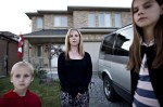 Angry resident Anne-Marie Vansickle stands with her children Kai and Kierra in the front yard of her home which edges onto the disputed land.