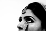 An Indian bride has her makeup touched up before her wedding ceremony. 