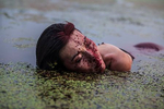 Beijing, Aug.4, 2018  performance artist Han Bing acts during an art project in a polluted lake on the outskirts of Beijing.