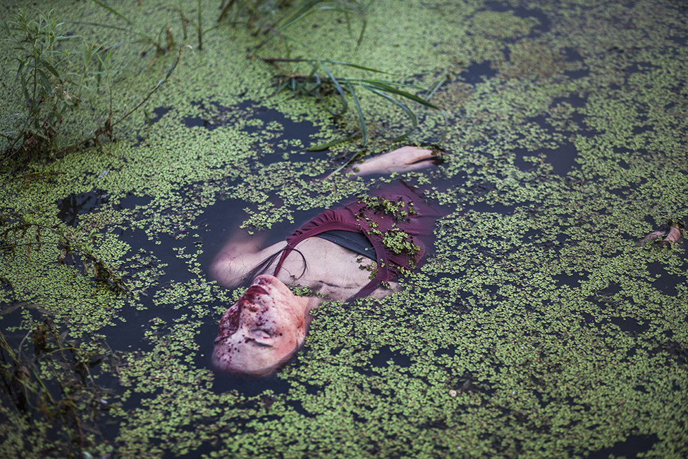  Beijing, July 30 : performance artist Han Bing lies in a polluted lake during an art project in a polluted lake on the outskirts of Beijing.