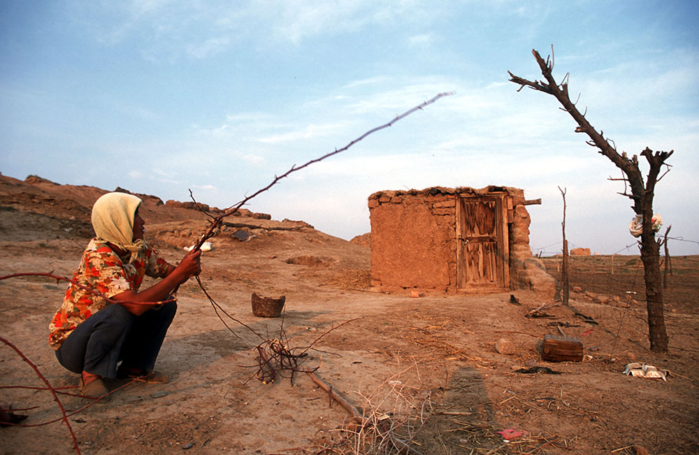 a sheperd from the Hui minority breaks firewood outside a shack on barren grasslands in central China's Ningxia province. According to the UNDP, desertfication has devoured 55.8%, or 2.89 million hectares of Ningxia's total terrain. An additional 1.21 million hectares grassland and 132.000 hectares farmland are under the threat of dsertification. The livelihood of inhabitants in 13 cities , 40 townships and 600 villages has been severely affected and the region's vulnerable natural environment is also at stake. Ningxia is one of the major sources of sandstorms which have a major impact on Northern China.Photo by @hessekatharina #desertification #climatechange #china #ningxia #globalwarming #climatechangeisreal