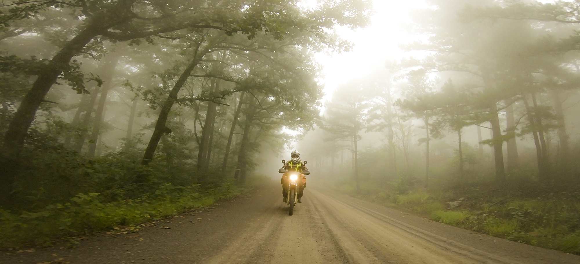 Motorcycling through the Ozark National Forest, Arkansas, on the Trans America Trail. This 5600 mile trail is a primarily off-road trail across the the United States starting at the Atlantic Ocean in North Carolina and ending in Oregon at the Pacific Ocean. 