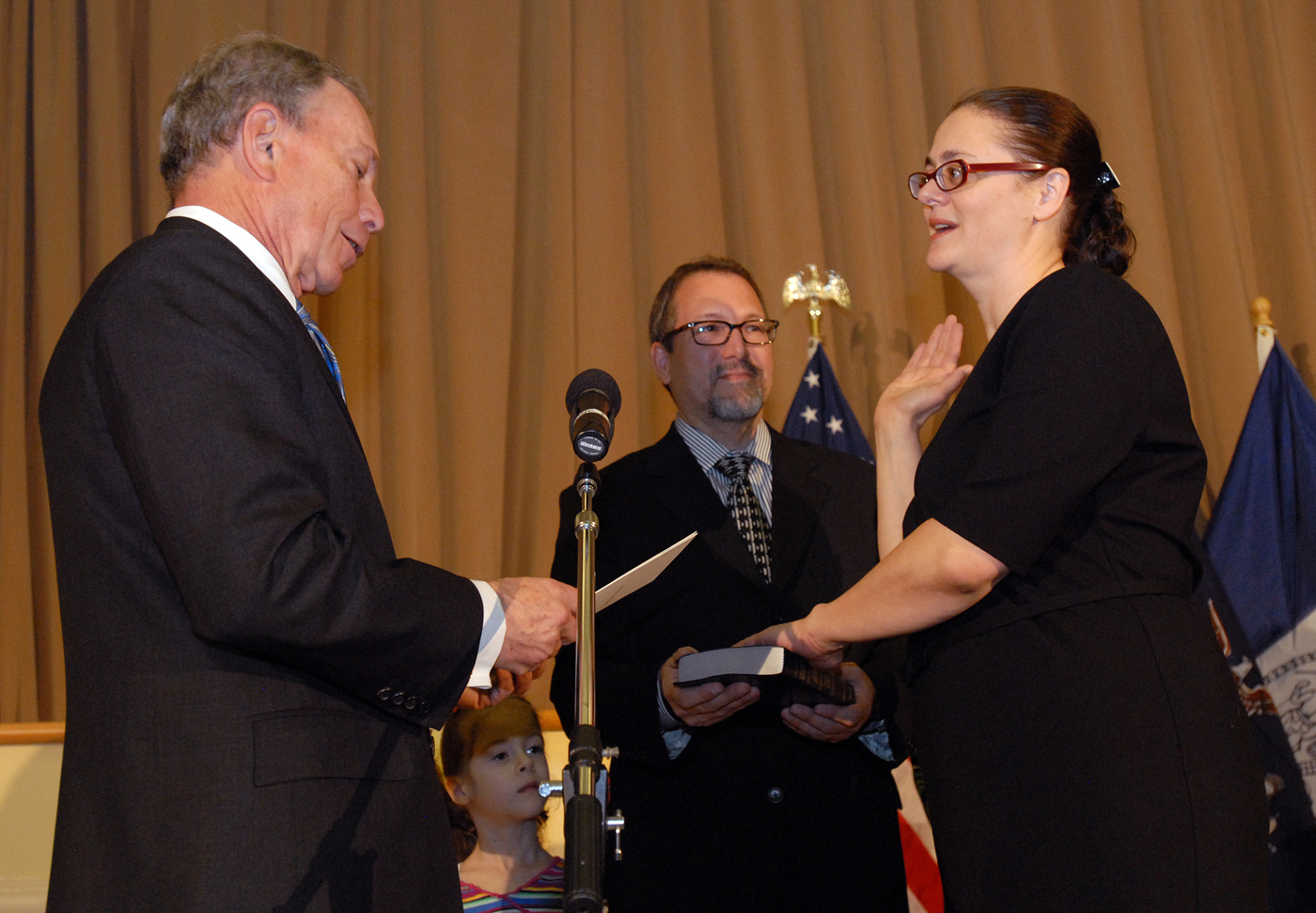 Mayor Michael R. Bloomberg swears in Amanda White as a newly appointed judge of the Civil Court. Holdiong the bible is Brad Phillips, her husband. Also present were thier twin girls, Sydney ans Sian.  The ceremony was haeld at the Emigrant Industrial Savings Bank Building 49 Chambers StreetFebruary 14, 2013