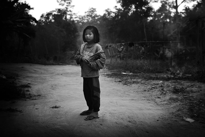 Ethnic Karen girl stand amid almost empty village