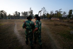 PLA female fighters check their mobile phone while returning from training in Lishengam memorial brigade conatonment in Kilali in far western region of Nepal. Some 6,000 female fighters waiting to be intergrated in the Nepal Army. 