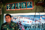 Deputy brigade commander of the Lishengam memorial brigade of People's Liberation Army, Major Aasha Chaudasi in front of a dormitory wall decorated with photos of Marx, Engels, Lenin, Stalin, chairman Mao and Nepal Maoist chairman Prachanda in Kilali PLA cantonment in far western region of Nepal.