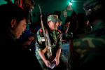 A PLA fighter talks to his commrades in the dormitory of the Lishengam memorial brigade, PLA cantonment in Kilali, far western region of Nepal.