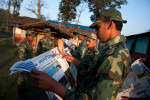 A PLA fighter reads at loud for its comrades news paper articles during the break between training activities in Lishengam memorial brigade cantonment in Kilali far western region of Nepal.