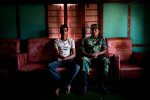 PLA fighter Shangharsha Deuwa (Left) sits beside its comrade medical doctor Manraj Shahi who amputated his right hand in 2005. Shanharsha joined Maoists guerrillas when he was 17 years of age since then he got involved in making improvised explosive devices. He lost his right hand while making a land mine. 
