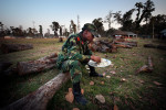 A PLA fighter eats dinner while sits on the log in PLA cantonment in Kilali, far western region of Nepal. 