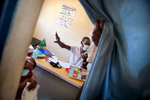 A doctor prepares to check up the child at the CRENAM clinic. During the screening for malnutrition children are referred to the doctor for thorough medical examination in order to identify possible further complications that Severe Acute Malnutrition may have been caused by.   In the Mbera refugee camp, the Nutrition survey carried out in November 2014 showed a significant decrease of both global acute malnutrition (from 11.8 to 9.9%) and severe acute malnutrition (1.4% to 0.8) rates. As of today, UNICEF has been supporting the government nutrition center in the treatment of 444 severe acute malnutrition (SAM) cases and contributed to the treatment of 790 other SAM cases. 