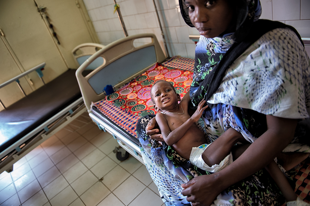 Mohammad Olud Barack 2 years old child with severe acute malnutrition, sits on the lap of his mother at the intensive care unit of CRENI in Aleg.Mohammad was admitted to CRENI for treatment of severe acute malnutrition two days earlier.