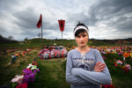 Luljeta Duraku in front of graves of 241 Kosovar Albanians who were massacred by Serbian forces between 25 and 27 March 1999.