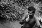 An Internally Displaced Person of Muttur brushes his teeth in the irrigation canal near the Railway station camp for displaced persons in Kanthale, Trincomalee.Fierce battle over Muthur town in eastern Sri Lanka between Tamil tiger rebels and the Sri Lankan forces pushed some 45,000 strong Muslim community into displacement.