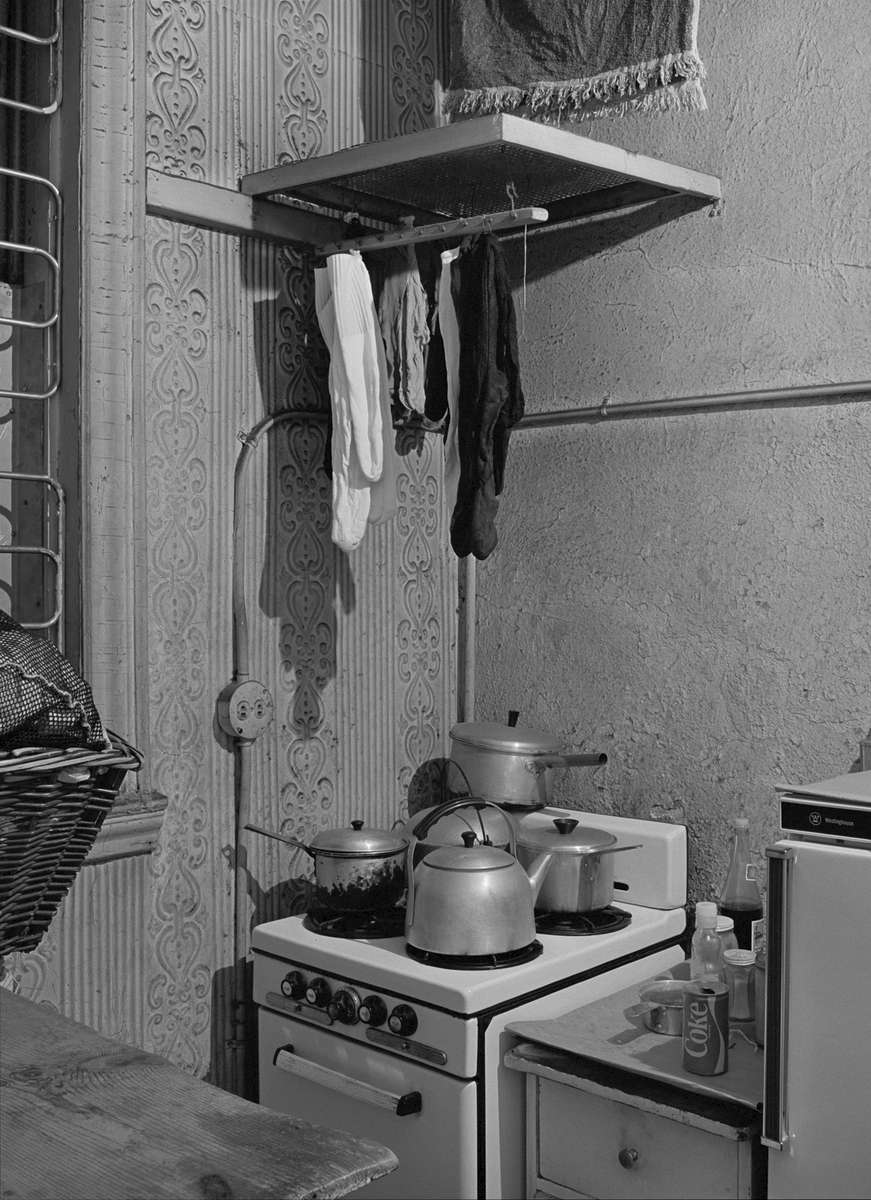 Back room, Sam Wah Laundry, Bronx, New York, 1982. Owners often lived in their laundry so kitchens and beds were a typical feature of these work spaces.