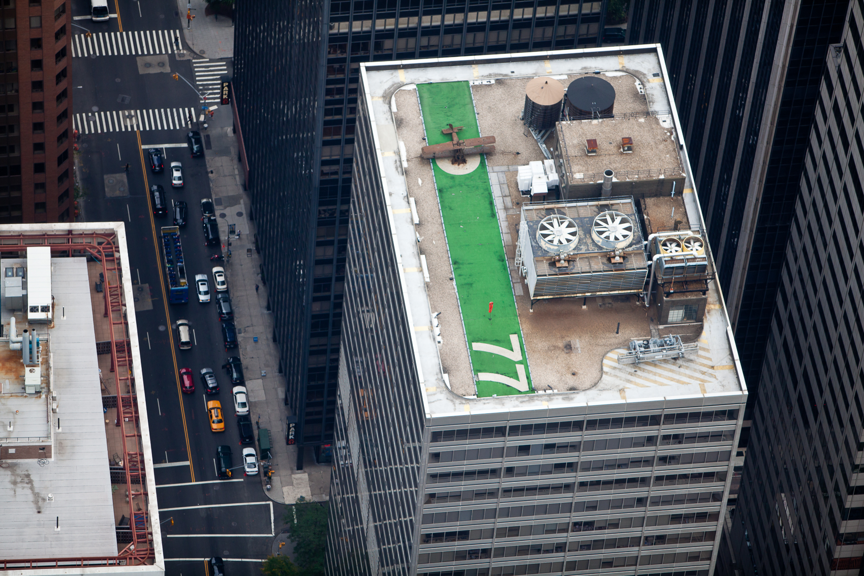 77 Water Street, Financial District, Manhattan: Model airplane permanently landed on green landing strip is a distraction from the rooftop mechanical units.