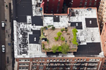 Roof deck surrounded by white roofs in the Greenwich Village neighborhood of Manhattan.  White Roofs reflect up to 90% of sunlight, which would otherwise be turned into convective heat energy if absorbed by a black roof, reducing the Urban Heat Island effect.