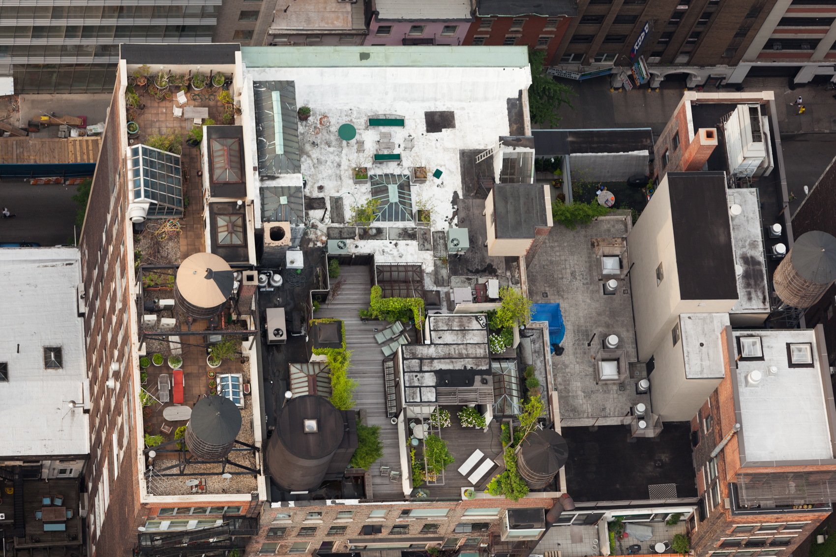 12 E 12th St, East Village, Manhattan, NY, 10003, 40.734066,-73.993769, LOCATION: Contiguous apartment buildings with different rooftop build-outs.  Wood decking and tiles are used to protect the roof's waterproof membrane. No such protection appears on the white roof in the back.