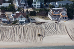 Following Hurricane Sandy in 2012, sand was regraded in attempt to create an artificial barrier dune for future high tide and surge protection in Brick, New Jersey.