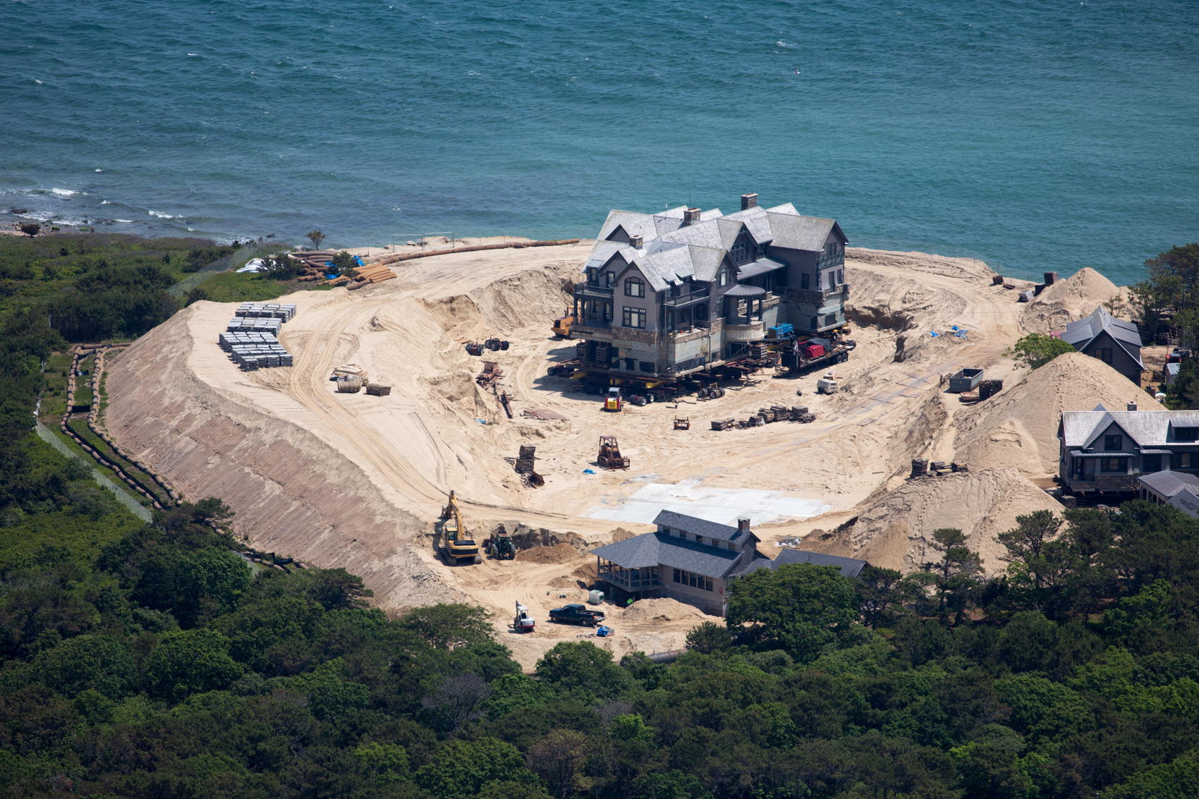 An 8,000 square foot house in Chappaquiddick, Massachusetts on Martha’s Vineyard is moved inland from a precarious perch on an eroding bluff.